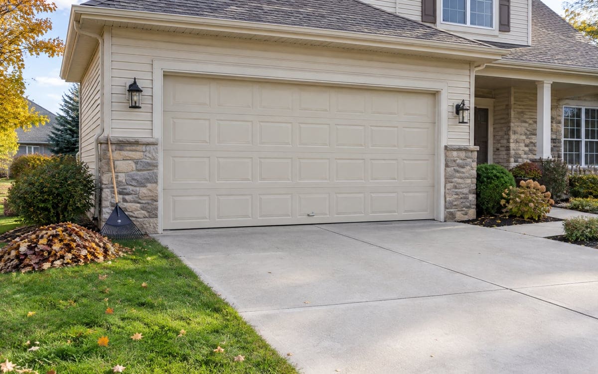 A well-kept two-car door in early fall, the season for a garage door tune up.