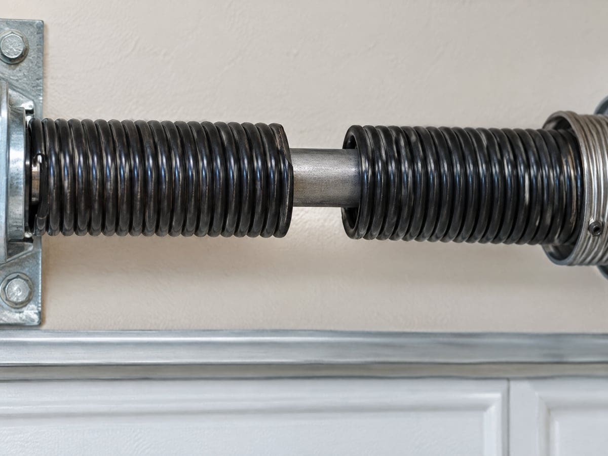 Close view of the gap in a broken torsion spring, the usual reason for garage door spring repair.